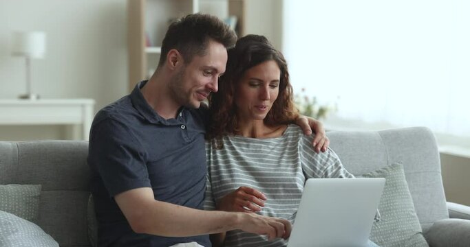 Happy Hispanic couple receive sale-out offer by e-mail, feels excited enjoy great, fantastic, unbelievable commercial proposal, buy services, get opportunity of last-minute travel tour. Win, success