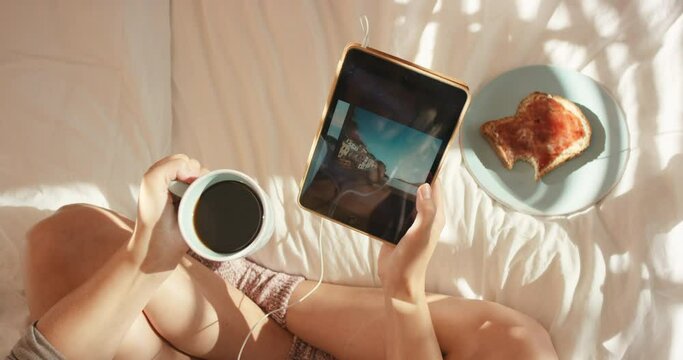 Tablet, movie or girl hand with coffee on bed for breakfast in morning, streaming video or social network app top view. Food, tech or woman relax in bedroom, scroll search social media or internet