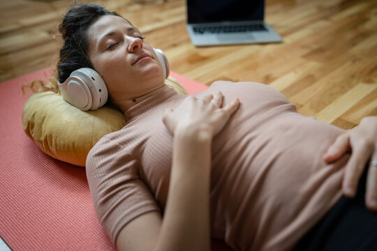 One Woman Doing Guided Meditation Yoga Self Care Practice At Home