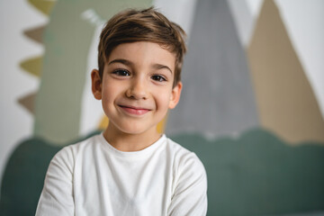 One boy caucasian child six years old kid in his room at home portrait