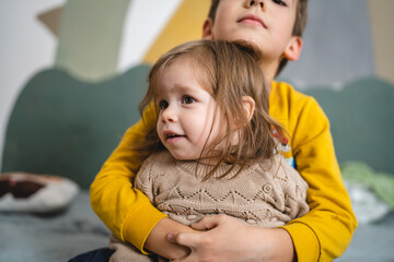 siblings portrait caucasian boy and girl brother and sister at home