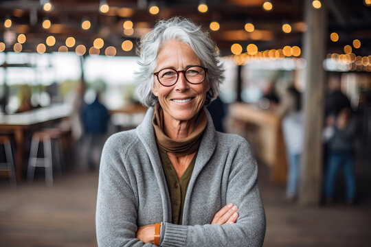 A smiling woman with her arms crossed