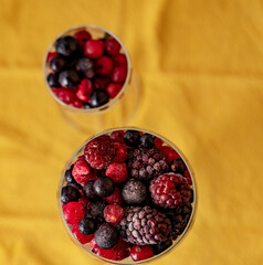 two glass goblet with red berries.