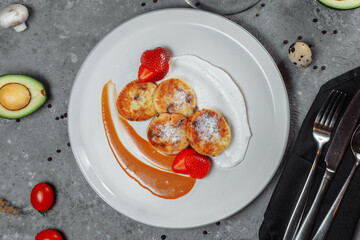 Sweet delicious food for breakfast. Pancake cheesecakes with fresh strawberry, blueberry and maple syrup. Delicious tasty pancake, morning food in cafe.