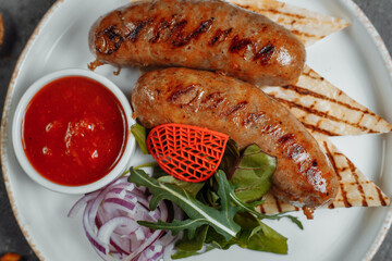 Grilled tasty bratwurst sausages on the plate