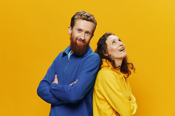 Obraz premium Man and woman couple smiling cheerfully and crooked with glasses, on yellow background, symbols signs and hand gestures, family shoot, newlyweds.