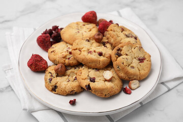 Cookies with freeze dried fruits and nuts on white marble table, closeup