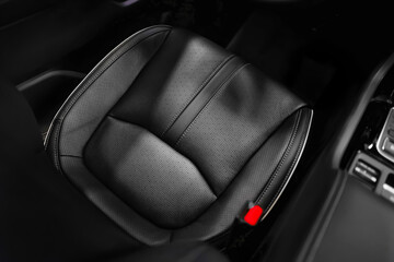 High angle view of luxury sport car front driver seat and leather fabric texture. Design element, car interior and detailing background.