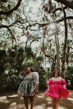 2 friends walk in the forest smiling