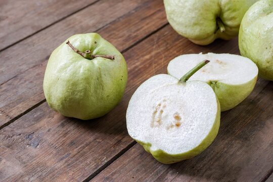 Guava fruits on a wooden table. Malaysian people are called Jambu Batu.