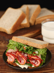 Toast bread sandwich with bacon and vegetables and wheat, indoor shot