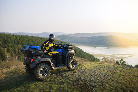 Man driving off road adventure with ATV car,  quad bike on the mountain.