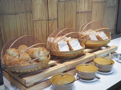 Buffet hommade bread bakery in bamboo basket for breakfast at hotel.
