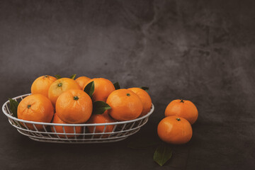 Orange or Mandarin in a wire basket.