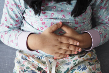  child suffering stomach pain close up.