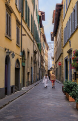 Tourists walk in a medieval street in Centro Storico, Florence, Italy