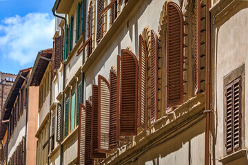 Arched wooden shutters on a building near Santa Croce Basilica, Florence, Italy