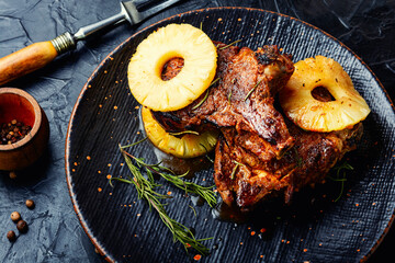 Roasted meat with pineapple rings.