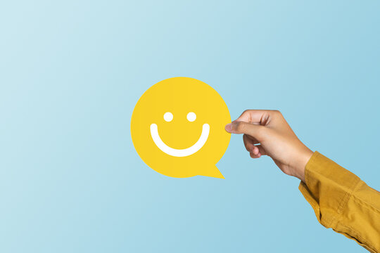 Customer show speech balloon with smile emoticon for rating. Service rating, feedback, satisfaction concept