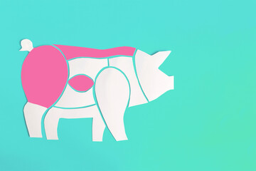 The scheme of cutting pork carcass from cardboard on a light background where the most delicious parts are highlighted in pink