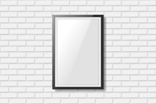 Blank black picture frame on white brick wall