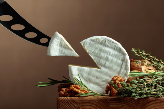 Brie cheese with walnuts, thyme, and rosemary.