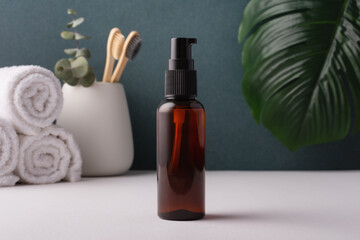 Cosmetic brown bottle with dispenser in minimal bathroom interior