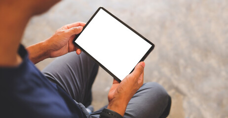 Man hands holding digital tablet with white screen.