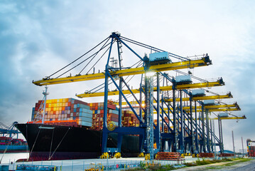 crane loading cargo container import container ship in the international terminal logistic sea port...