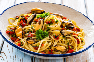 Spaghetti with clams on wooden table
