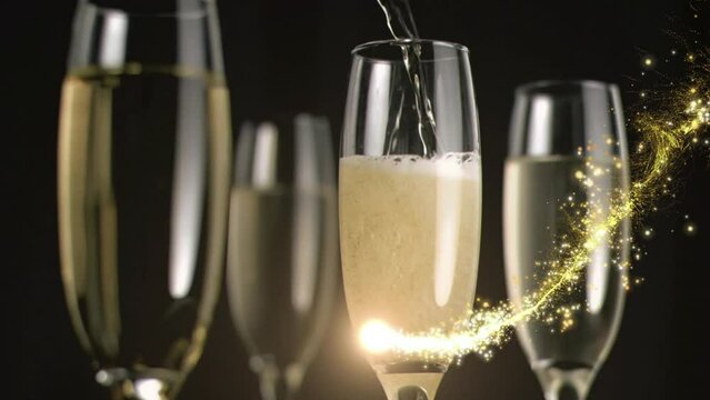 Animation of moving lens flare over champagne glasses and champagne getting poured in empty glass