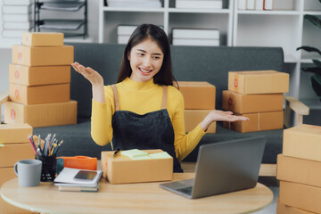 tarting Small business entrepreneur SME freelance,Portrait young woman working at home office, BOX,smartphone,laptop, online, marketing, packaging, delivery, SME, e-commerce concept