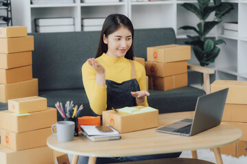 Fototapeta na wymiar tarting Small business entrepreneur SME freelance,Portrait young woman working at home office, BOX,smartphone,laptop, online, marketing, packaging, delivery, SME, e-commerce concept