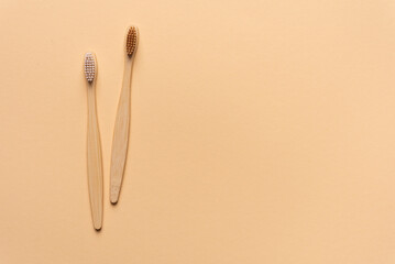 Eco-friendly bamboo toothbrushes on yellow background.