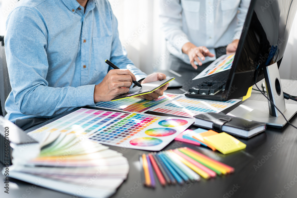 Poster two creative graphic designer team working on color selection and drawing on graphic tablet, color s
