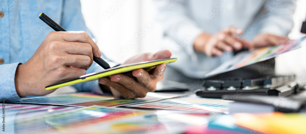 Poster two creative graphic designer team working on color selection and drawing on graphic tablet, color s