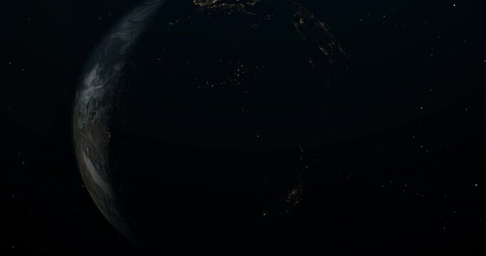 Planet Earth in open space, with a clearly visible terminator line dividing the planet into the bright daylight side and the dark nighttime side. The nighttime side showcases the lights of cities.
