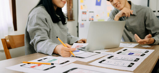 UX graphic designer planning application process development prototype wireframe for web smart phone. Creative digital development agency. in office