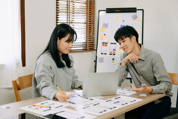  UX developer and ui designer brainstorming about mobile app interface wireframe design with...