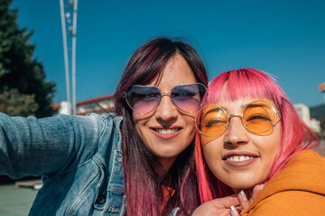 friends taking a selfie or live video with the phone in the street