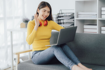 Asian woman enjoy listening to music and drinking coffee and laptop computer in the morning