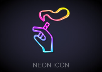 Glowing neon line Hand with smoking cigarette icon isolated on black background. Tobacco sign. Vector