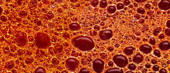 Oil bubbles in the water on a colored background. Colorful pattern of oil in water. Abstract liquid backdrop