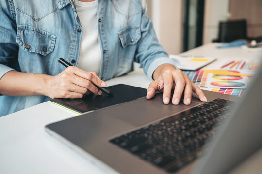 Young creative graphic designer working on color selection and d