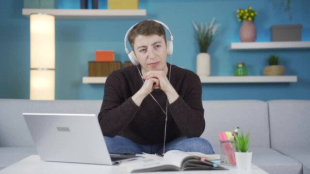 Thoughtful and sad student listening to emotional music.