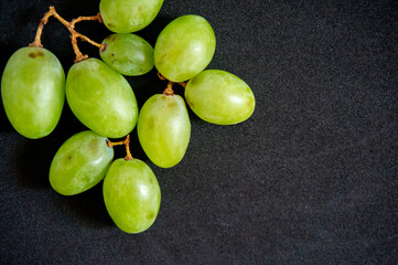 Fresh green grapes isolated on a black background