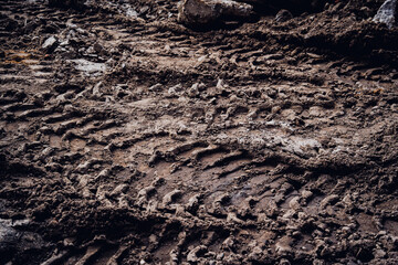 Excavator tire tracks footprint on construction road site