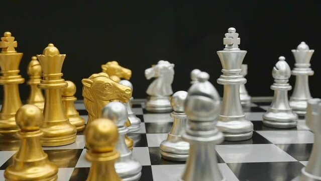 A close-up panning shot of a female hand playing chess pieces. The concepts of business strategy, planning management, success and leadership.
