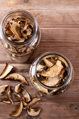Dried mushrooms. Mushrooms in jar on the wooden table. Top view