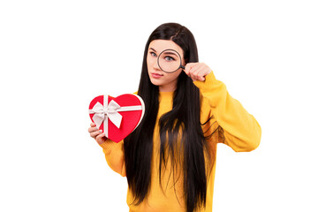 girl in a yellow sweater with a gift and a magnifying glass in her hand, the concept of search for a gift isolated on transparent background